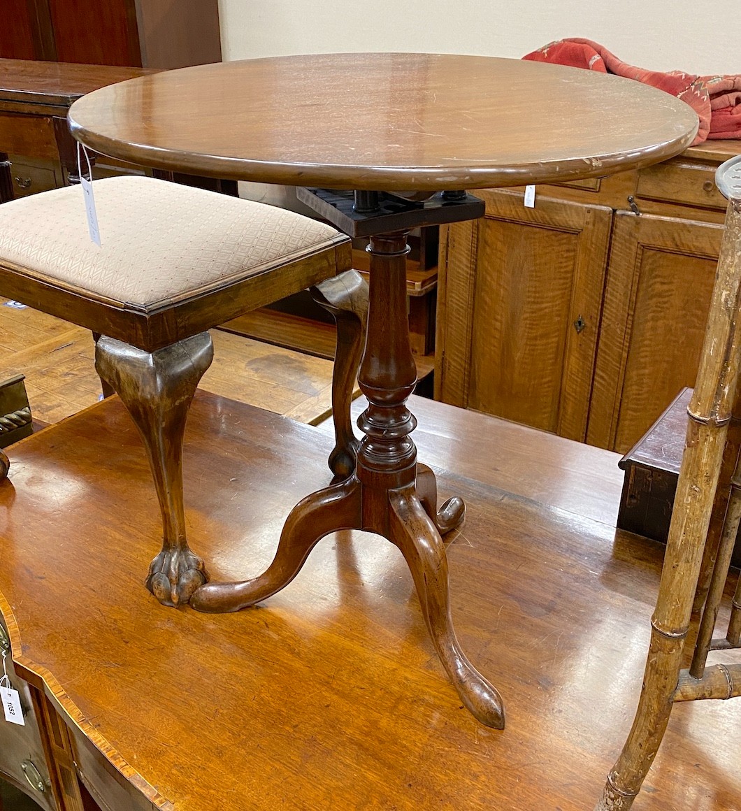 A George III mahogany bird cage tilt top tripod tea table diameter 64cm, height 68cm.